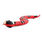 Red and black toy snake on a white background
