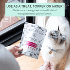 Cat food package with a cat looking at it, held by a person.