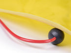 Close-up of a red and black toy with a yellow background